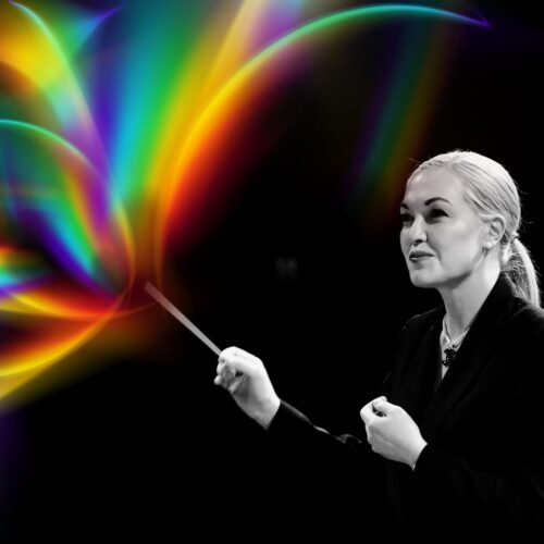 Sarah Grace Williams conductor TMO with rainbow flare from baton
