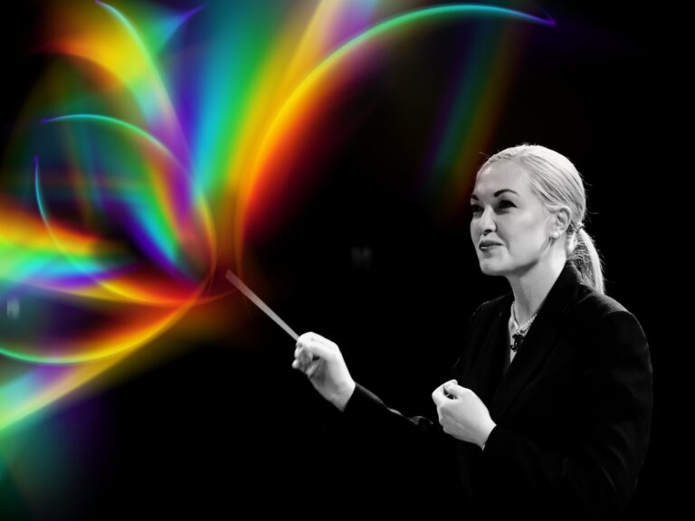 Sarah Grace Williams conductor TMO with rainbow flare from baton